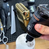Barber applying JesseElite Matte Brown 2.0 semi-permanent enhancement in the shop — from Instagram @jesseelite (via @barbermeeks)